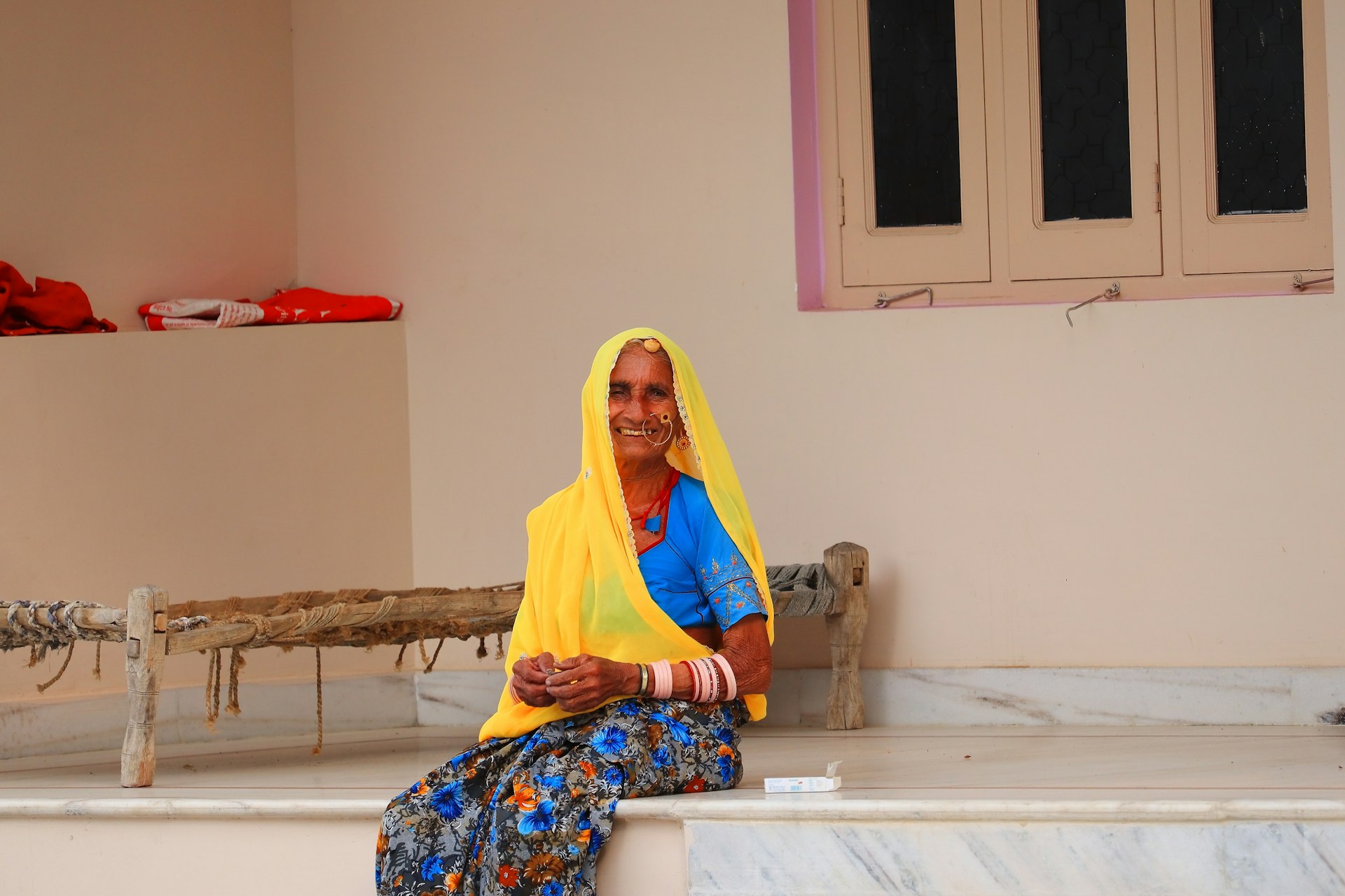 woman in yellow hijab sitting on white wooden table